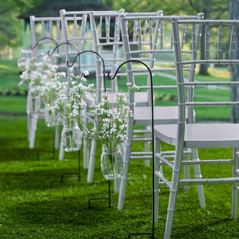 Enhance the outdoor decorations for your big day! This convenient decorating kit includes faux flower arrangements that will dress up your outdoor wedding aisle. Browse our site to find aisle runners and more to create the perfect look for your wedding ceremony. (72 pcs. per unit)Includes:o 36 Plastic Baby's Breath Faux Floral Stems (13 3/4")o 12 Metal Black Metal Shepherd's Hooks (32")o 12 Glass Pint Mason Jars with Lids (5")o 12 Metal Rustic Mason Jar Hangers (5 1/4") o Assortments are subject Hanging Mason Jar Wedding Aisle, Wedding Decor Aisle Outdoor, Wedding Aisle Flowers In Vases, Simple Wedding Walkway Decor, Simple Outdoor Aisle Decor, Whimsical Ceremony Aisle, Aisle Decor Wedding Outdoor, Outdoor Lights For Wedding, Simple Wedding Benches