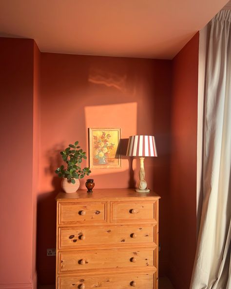 1 Cosy Bedroom Corner 🕯️ ✨- in 4 ways! Which is your favourite? Although this bedroom was only decorated just over a year ago this shows how much I like to shift furniture around! But really this post is to hail the impact of this beautiful warm terracotta paint colour on this previously greyish north facing room! Captured in different seasons and lights - this room still glows! Have you got a paint colour that never fails to evoke warmth and cosiness? I also think this is me slowly easing ... Bedroom With Color Wall, Terracotta Red Bedroom, Red Earth Bedroom, Red Painted Room, Dulux Copper Blush, Cosy Colourful Bedroom, North Facing Bedroom, Terra Cotta Bedroom, Coloured Bedroom