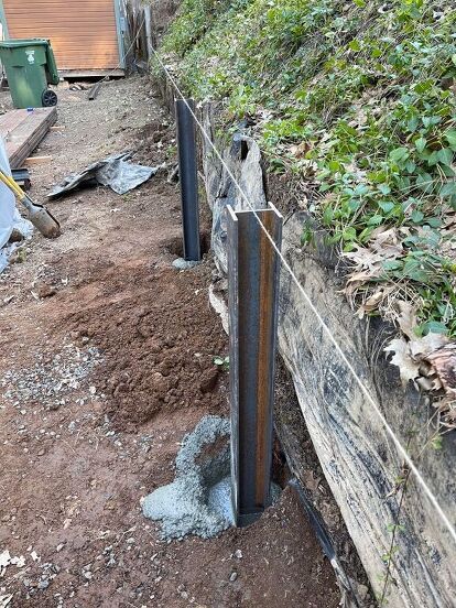 This is a BIG and expensive project! We have several retaining walls on our property that need to be redone. The photo below shows just one of the walls that is falling down (we are looking at the lower wall, light green wood). We decided to tackle these walls one section at a time, as money and time allow. If you are looking for a way to build/replace retaining walls, doing this yourself will take time and muscle, but save you thousands of dollars. (By the way, the fenced in "boxes" u… Steel Retaining Wall, Wood Retaining Wall, Diy Retaining Wall, Backyard Retaining Walls, Concrete Retaining Walls, Sloped Backyard, Landscaping Retaining Walls, Front Yard Landscaping Simple, Front House Landscaping