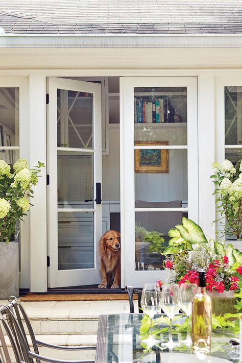 The Patio Doors Open Up the Exterior - A Dramatic Ranch House Renovation - Southernliving. "Ranches tend to have 8-foot ceilings and not a lot of natural light, making them feel cramped," Evans notes. Three new sets of 7-foot-tall French doors significantly brighten up the interior rooms surrounding the patio and allow people to move indoors and outdoors much more easily. Ranch House Renovation, Architecture Renovation, Front Door Makeover, French Doors Exterior, French Doors Patio, Front Steps, Ranch Style Home, French Doors Interior, Door Makeover