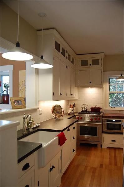 Lovely farmhouse kitchen in a 1920's home. white kitchen cabinets, farmhouse sink, soapstone countertops 1920 Kitchen Design, Kitchen Countertop Remodel, 1920 Kitchen, Countertops Farmhouse, Countertop Remodel, 1920 Home, 1920s Kitchen, Hgtv Kitchens, Small Cottage Kitchen