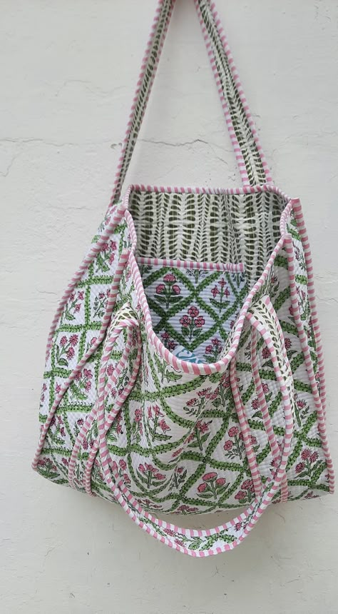 The Indian Hand Block Printed Cotton Quilted Women's Handbags from Rajasthan India. This Handbag is completely Indian Printed on good quality cotton. Cotton quilted travel Bag made by Indian Artisans, this cotton quilted shopping bag is totally unique and multi purpose. Use this for your grocery or as a travel bag. Perfect to suit all. Perfect Gift For her Item :- Cotton Handbag Material: 100% Cotton Pattern: Floral Print Was Care - Home Washable Style: Tote Bag Tote Bag -  Color - (we will Send Assorted Color And Pattern) Size in Inch:- Height-17" inch Width- 15" inch Handle-12" inch Product Work: Printed & quilted Stitched Usage : Cosmetic, Make-up, Travel, Toiletries, Medicine, Accessories, Shopping and much more. Perfect for Beach Visits/ Quick Grocery runs/ Carrying Kids items/ Artist Quilted Canvas Bag, Unique Purses And Handbags, Indian Bags, Quilt Bag, Floral Block Print, My Style Bags, Indian Quilt, Ethnic Bag, Vintage Tote Bag