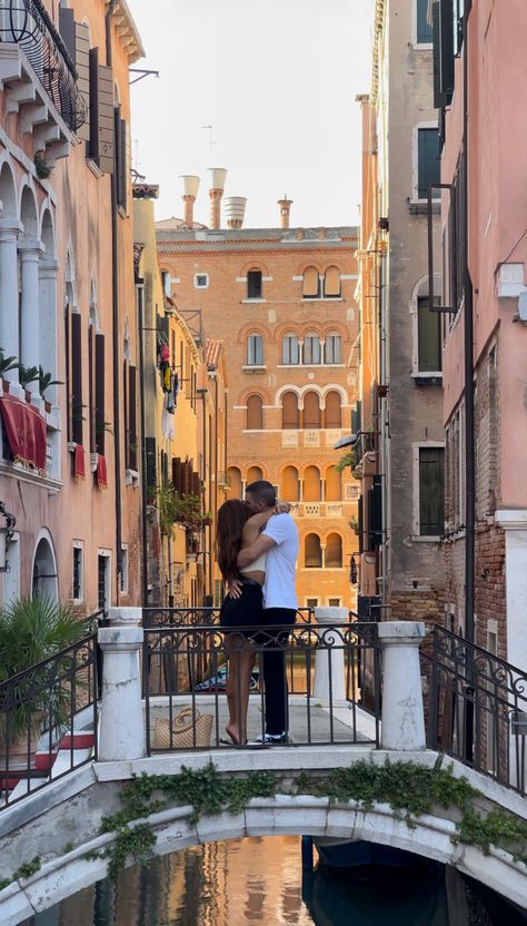 A couple hugging on a bridge in Venice Italy Italian Relationship Aesthetic, Couple Vacation Pictures Italy, Venice Italy Honeymoon, Italy Travel Couple, Italy Travel Aesthetic Couple, Traveling With Partner Aesthetic, Travel With Partner Aesthetic, Venice Couple Aesthetic, Europe Honeymoon Aesthetic