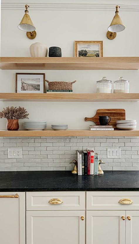 Light Wood Open Shelving Kitchen, Floating Wood Shelf Kitchen, Lights Over Open Shelves In Kitchen, Lights Over Floating Shelves Kitchen, White Oak Shelf, Wood Open Shelves Kitchen, Floating Shelves With Sconces, Oak Floating Shelves Kitchen, Floating Wood Kitchen Shelves