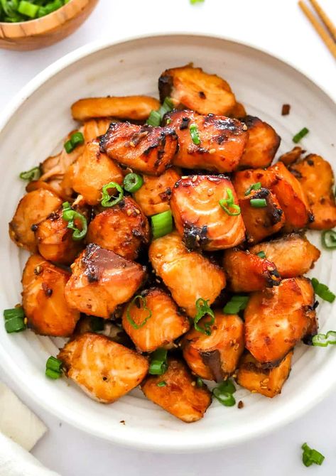 These teriyaki air fryer salmon bites are made with succulent salmon chunks marinated in a sweet and savory teriyaki sauce, these bites are crispy on the outside and tender on the inside. Plus, they're cooked in an air fryer, which means they're healthy, and lower in fat and calories than traditional fried foods. Serve them as an appetizer, snack, or light meal, and enjoy the flavor-packed goodness!" Salmon Chunks Air Fryer, Salmon Air Fryer Bites, Air Fried Salmon Bites, Salmon Bites Air Fryer, Teriyaki Salmon Bites, Salmon Chunks, Air Fryer Recipes Salmon, Salmon Bites Recipe, Oven Salmon