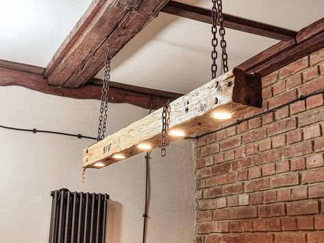 Beautiful wooden hanging lamp in rustic style of light shade. In my offer you will also find the same lamp in a darker shade: https://www.etsy.com/pl/listing/888522762/duga-drewniana-lampa-z-belki-wiszca-na?click_key=768f74fe7dad198f81732eedde86ef957b505a0b%3A888522762&click_sum=9a64e090&ref=shop_home_feat_4&sts=1 The lamp was made of an old beam with a history, thanks to which the lamp has its own character. In the lamp there are old fittings, such as nails or screws, which are visible on the b Cabin Light Fixtures, Hanging Beam, Barn Beam Lighting, Wooden Hanging Lamp, Chain Lamp, Rustic Loft, Make A Lamp, Industrial Wood, Rustic Home Design