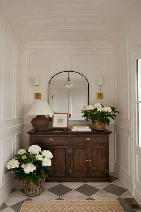 Beautifully styled vestibule boasts a stunning brown wooden cabinet placed on black and white marble harlequin floor tiles beneath brass sconces flanking a black arch mirror. Home N Decor, House Inspo, Decor Bedroom, First Home, House Inspiration, Entryway Decor, Home Decor Inspiration, Vintage Decor, Bedroom Interior