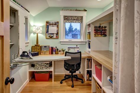 Mint green walls add a soft but effective color to this cozy sewing room. Built-in shelving, thread storage and a folding ironing board keep the room organized and functional. Light wood countertops complement the hardwood flooring. Farmhouse Sewing Room, Small Sewing Space, Small Sewing Rooms, Built In Cubbies, Sewing Area, Mint Green Walls, Sewing Room Inspiration, Sewing Spaces, Sewing Room Design