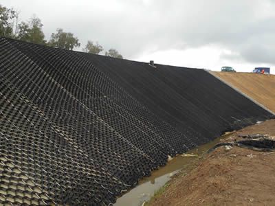 Erosion Control Mats Protect Slope from Water & Soil Loss River Erosion Control, Erosion Control Landscaping Slope, Slope Landscaping Ideas Erosion Control, Steep Hillside Landscaping, River Rock Landscaping, Landscaping Retaining Walls, Drainage Solutions, Hillside Landscaping, Erosion Control