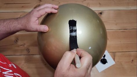 This festive season, we're diving into a fun and budget-friendly project using inflatable balls from your local dollar store or Dollar Tree. Let's get started on how to make giant jingle bells! Giant Jingle Bells, Getting Rid Of Mice, Gold Spray Paint, Gold Spray, Black Acrylic Paint, Paint Marker, Jingle Bell, Christmas Bells, Spray Painting