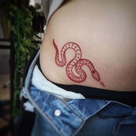 red snake tattoo women hip Red Snake Tattoo, Hellboy Tattoo, Flower Spine Tattoos, Stomach Tattoos Women, Tato Minimal, Red Rose Tattoo, Red Snake, Fire Tattoo, Spine Tattoos For Women