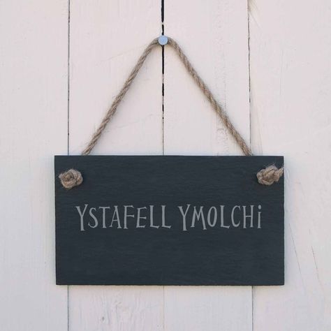 PRICES MAY VARY. A beautiful hand crafted natural slate hanging sign, it is 4mm thick and hung with jute rope. The message 'Ystafell Ymolchi' is laser etched onto the slate. Suitable for indoor or outdoor use this sign is the perfect gift for in and around the home or garden. Dimensions: 18 x 10 x 0.4cm (not including rope). This hand crafted, natural slate hanging sign is 4mm thick and hung with jute rope. The message 'Ystafell Molchi' is laser etched onto the slate. Suitable for indoor or outdoor use this sign is the perfect gift for in and around the home or garden. Dimensions: 18 x 10 x 0.4cm (not including rope).