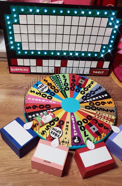 Wheel of fortune  Christmas edition Wheel Of Fortune Party, Wheel Of Fortune Game, Diy Gift Card, Work Activities, Dining Room Storage, Wheel Of Fortune, Window Displays, Game Night, Moccasins