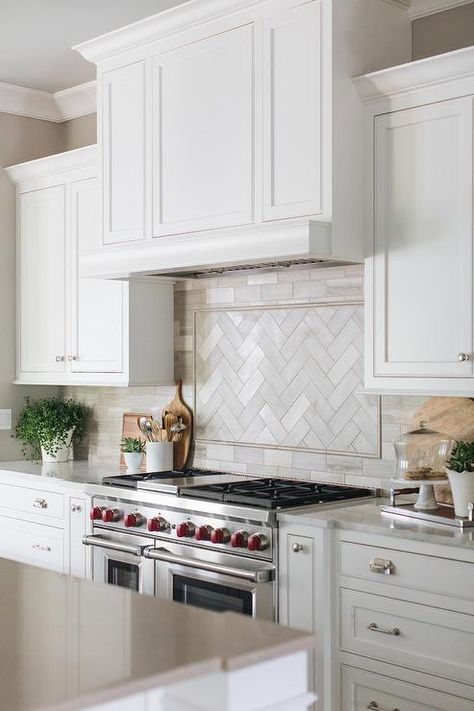 White shaker kitchen cabinets flank a white wood range hood mounted against beige backsplash tiles fixed framing beige herringbone cooktop tiles. Modern Farmhouse Kitchen Backsplash, Farmhouse Kitchen Backsplash Ideas, Calcutta Gold, Marble Backsplash Kitchen, Farmhouse Kitchen Backsplash, Stove Backsplash, White Kitchen Backsplash, Kitchen Backsplash Designs, New Kitchen Cabinets