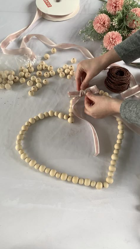 DIY Wood Bead Heart with pink velvet ribbon bow for Valentine's Day. Beaded Heart Wreath Ideas, Wooden Bead Heart Wreath, Heart Crafts For Adults, Wood Bead Heart Wreath, Beaded Heart Wreath, Valentine Gifts To Make, Wooden Hearts Diy, Wood Heart Crafts, Diy Wood Bead Garland