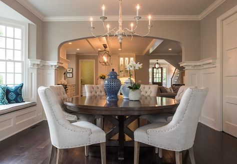 A centerpiece in this dining room is a round wooden mahogany dining table with gorgeous beige tufted chairs accenting nailhead trim. Tufted Chairs, Mahogany Dining Table, Mahogany Furniture, Kitchen Table Chairs, Minnesota Home, House Of Turquoise, Round Dining Room, Studio M, Table Round