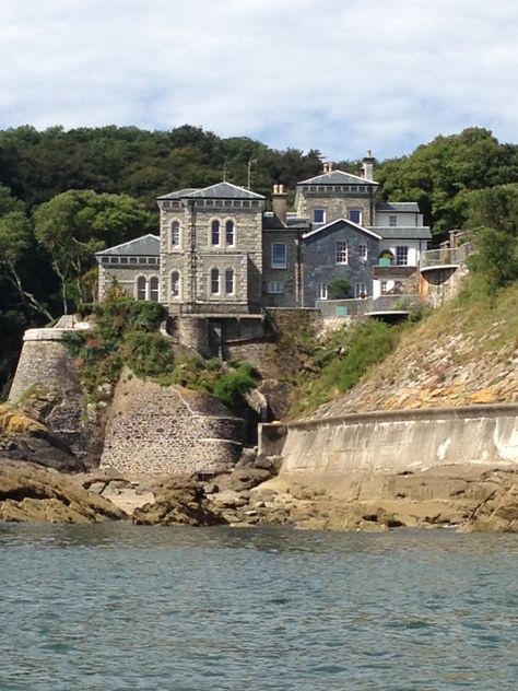 POINT NEPTUNE HOUSE: 'Grade II listed building Circa mid C19; extended and remodelled 1864 for William Rashleigh of Menabilly; (Mayor, Lostwithiel 1802, 1808; Sheriff, Cornw. 1820-1.Capt. R. Stannary artillery 1803). It was extended again later C19; altered C20. The original mid C19 house is of painted brick, partly slate-hung and with low-pitched slate roof with deep eaves and verges to gable ends. A good example of a Victorian Italianate villa overlooking the Fowey estuary.' ✫ღ⊰n Fowey Cornwall, Irish Countryside, English Castles, Cornwall England, Slate Roof, Listed Building, Painted Brick, Places Of Interest, Stone House