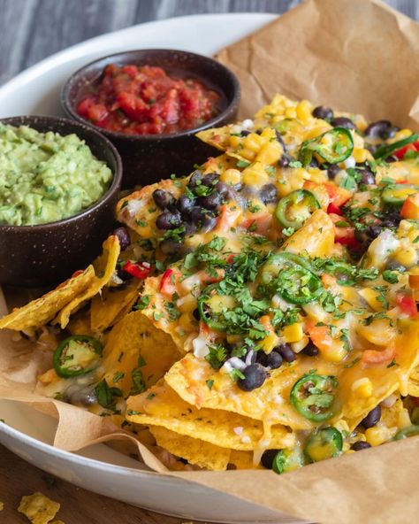 When it comes to game day party grub, these Loaded Vegetarian Nachos are a surefire winner! 🏈 🎉 Layers of crunchy tortilla chips, black beans, corn, bell pepper, red onion, jalapenos, and ooey gooey melty cheese 🧀 come together to create the perfect touchdown-worthy snack! 🙌 Serve these mouthwatering veggie nachos with an array of your favorite dips like sour cream, salsa, and guacamole. 🍅🥑 Comment "nachos" below for the recipe! #SuperBowlFeast #GameDayEats #NachosForTheWin #vegetariannac... Nachos With Jalapenos, Nachos Vegetarian, Veggie Nachos, Salsa And Guacamole, Salsa Nachos, Teenage Party, Vegetarian Nachos, Black Beans Corn, Vegan Nachos