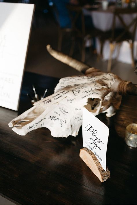 Cow skull wedding guest book with signatures for their boho southern wedding in Austin Texas Deer Skull Wedding Guest Book, Cow Skull Signing Wedding, Bull Skull Wedding Sign In, Deer Head Guest Book, Skull Guest Book Wedding Ideas, Deer Skull Wedding Decor, Cow Skull Guest Book, Wedding For Hunters, Different Wedding Guest Book Ideas