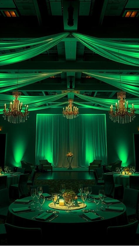 Elegant event venue with chandeliers, green drapery, and tables set for dining. Emerald City Wedding Theme, Emerald City Prom Theme, Royal Green Wedding, Emerald Green Theme Wedding, Dark Romantic Wedding Theme, Nubian Wedding, Emerald Green And Purple Wedding, Green And Gold Wedding Decor, Emerald And Gold Wedding Theme