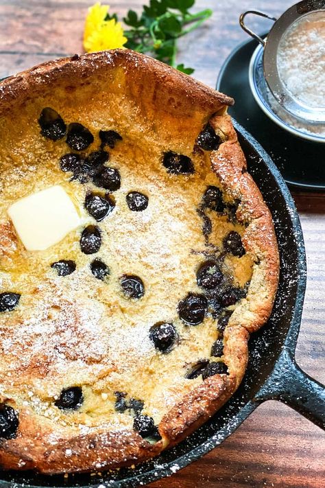 A Blueberry Dutch Baby is a quick and easy baked oven pancake, often called a German Pancake. Perfect for breakfast or bunch, its high puffs, crisp edges, and tender delicious center is such a treat that it just might become a weekend tradition! See how to adapt this easy recipe with different fruit and flavors. #breakfast #blueberries #pancakes #31Daily Blueberry German Pancakes, Savory German Pancake, Dutchbaby Pancake Recipe, Blueberries Pancakes, Blueberry Dutch Baby, Oven Pancake, Easy German Recipes, Brunch Pancakes, Sheet Pan Pancakes