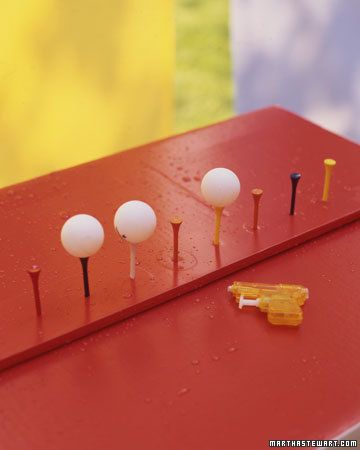 Spray-Away Game  The target table: a white box decorated with blue construction-paper waves and topped with red contact paper. We covered a strip of foam board with the same paper, inserted golf tees into it, and secured it to the box with double-sided tape.    The Rules of the Game  Kids get one ticket for each ping-pong ball they knock off a golf tee with spray from a water gun. Halloween Carnival Games, Kids Carnival, School Carnival, Bloc Party, Adult Halloween Party, Carnival Themes, Carnival Birthday, Carnival Games, Halloween Carnival