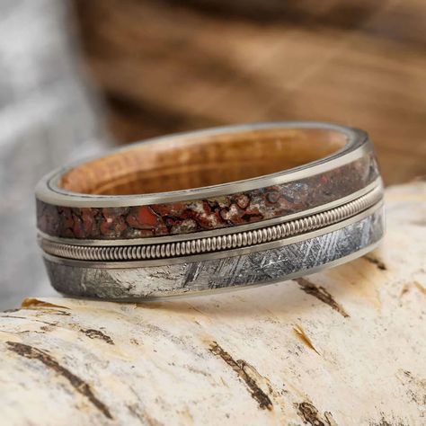 Perfect for the groom who loves music, this men's wedding band features a guitar string inlay. On one side of this wood wedding band is Gibeon meteorite, contrasted by the fossilized dinosaur bone on the other side. Solid gold pinstripes and edges decorate the sides of this unique ring. The color of the guitar string is coordinated with whatever gold color you choose for your order (rose, white or yellow). Or, you can supply your own guitar string (no additional cost) for a personal touch. The w Wood Wedding Rings For Men, Rustic Mens Wedding Ring, Wood And Gold Ring, Mens Outdoorsy Wedding Bands, String Rings, Guitar Wedding, Boho Wedding Bands, Groom Wedding Band, Ring Armor