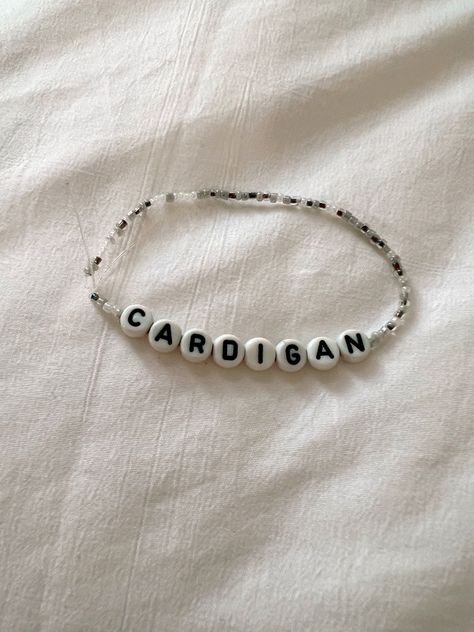 Silver seed bead bracelet saying cardigan for Taylor swift eras tour Taylor Swift Bracelets Seed Beads, Cardigan Friendship Bracelet, Bracelet Ideas Taylor Swift, Folklore Friendship Bracelet, Ts Bracelet, Taylor Bracelets, Eras Bracelets, Swift Bracelets, Taylor Swift Merch