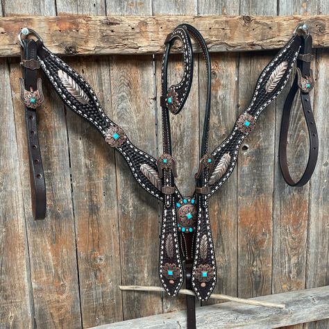 Browband, one ear and breastcollar is dark oil buckstitch style. They are decorated with copper feathers (W169) and turquoise fleur-de-lis western conchos and buckles (W141). Full Horse size Measurements Headstall measurements : bit to bit - 36" shortest setting : 44" longest settingBrowband measures 15" acrossBreastcollar measurements - From Center Ring to D Ring -16"Breastcollar including toggles : shortest settings - 26" : Longest settings -29" Buy Together or Separate BROWBAND ONLY - $244.00 Western Riding Tack, Western Tack Sets, Barrel Racing Tack Sets, Barrel Racing Tack Rodeo, Copper And Turquoise, Barrel Racing Tack, Country Things, Western Tack, Horse Things