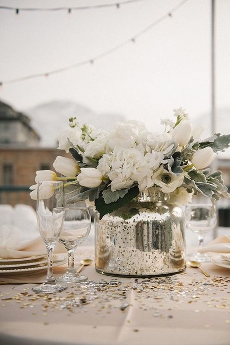 Gray and white neutral centerpiece, mercury glass vase. Would add pops of yellow, gold floral vase wedding dinner table Mercury Glass Centerpiece, Silver Winter Wedding, Winter Wedding Centerpieces, White Centerpiece, Practical Wedding, Rooftop Wedding, Glass Centerpieces, בר מצווה, May Weddings