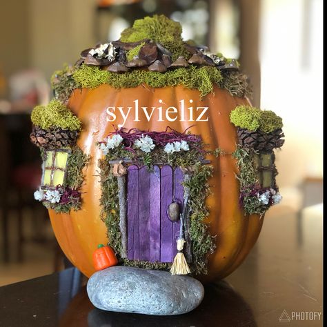 Faux pumpkin decorated with pine cones, moss, dried flowers, sticks, and imagination. Fairy pumpkin house. Painted Pumpkin Fairy House, Fairy House Jack O Lantern, Hobbit House Pumpkin, Fairy House Pumpkin Carving, Fairy Pumpkin Decorating, Pumpkin House Carving, Hobbit Pumpkin, Fairy House Pumpkin, Fairy Pumpkin