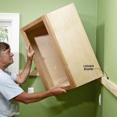 It's easier to hang the uppers when you're not hanging way over the base cabinets. Rest the uppers on a ledger board—it'll ensure a nice, straight alignment and eliminate the frustration of holding the cabinets in place while screwing them to the wall. How To Install Kitchen Island, Kitchen Cabinet Installation, Install Cabinets, Island Cabinets, Installing Kitchen Cabinets, Traditional Kitchen Cabinets, Cabinet Installation, Building Kitchen Cabinets, Diy Cabinet Doors