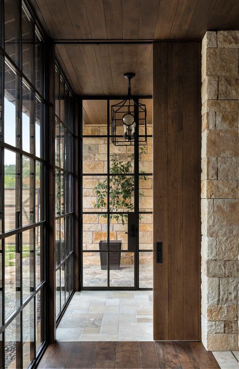 Floor-to-ceiling steel windows by Rehme Steel Windows & Doors appear in the primary hallway. They provide a clean counterpoint to dry-stacked Texas limestone walls, stone floors and stained Douglas fir ceilings. French Doors With Transom, Pintu Interior, Steel French Doors, Steel Doors And Windows, Doors Ideas, Swedish Decor, Industrial Door, French Doors Exterior, Double French Doors