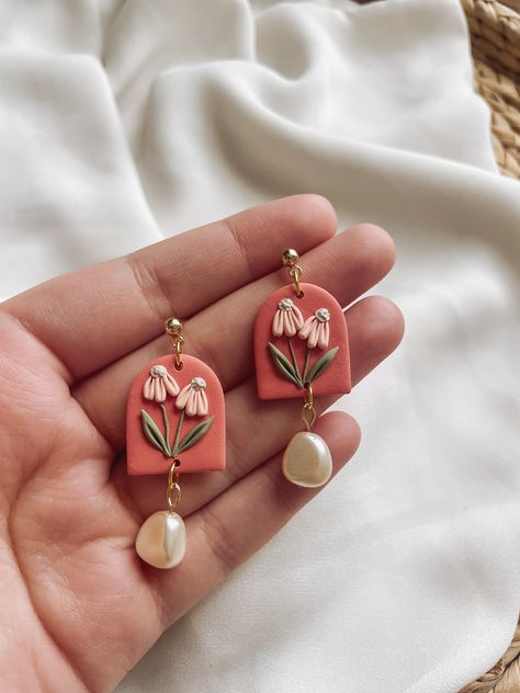 Achieve an elegant and sophisticated look with our "Promenade" Bridgerton-inspired floral clay earrings. Handmade with delicate floral details and pearls, these lightweight earrings add a simple statement to any outfit. Their soft colors make them the perfect accessory for a classic and timeless look. These earrings are made with gold-plated lightweight polymer clay and surgical stainless-steel posts (nickel-free). These earrings weigh less than 1oz and are approximately 1.2" in length. Polymer Clay Simple Earrings, Bridesmaid Clay Earrings, Polymer Clay Cabochons, Vintage Polymer Clay Earrings, Spring Polymer Clay Ideas, Clay Earrings With Beads, Clay Statement Earrings, Clay Floral Earrings, Clay Earrings Videos