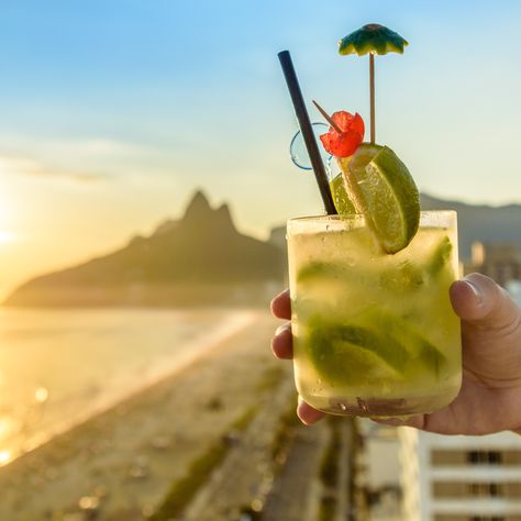 Enjoy the refreshing Brazilian National Cocktail, Caipirinha, by the beach on your next vacation to Brazil.  Customize your trip: https://www.southamerica.travel/Brazil-Tours/ Brazilian Drinks, Brazilian Drink, Caipirinha Cocktail, Spicy Drinks, Most Popular Cocktails, Famous Cocktails, Boozy Brunch, Copacabana Beach, Pisco Sour