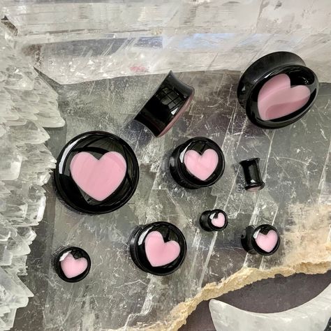 "WELCOME TO PINK ALIEN BABE  YOUR ONE STOP SHOP FOR ALL THE CUTEST PLUGS AND ACCESSORIES IN THE GALAXY 🪐⭐️ 🎀This is a listing for A PAIR (two pieces) of Aphrodite Inner Love ear plugs, black acrylic double flared gauges with baby pink hearts inside of them in your choice of size.  👽💕 Sizes available: 2g 6mm, 0g 8mm, 00g 10mm, 1/2\" 12mm, 9/16\" 14mm, 5/8\" 16mm, 11/16\" 18mm, 3/4\" 20mm, 7/8\" 22mm, 1\" 25mm, 28mm, 30mm, 32mm, 34mm, 36mm, 38mm, 40mm, 42mm, 44mm, 46mm, 48mm, 2\" 50mm 👽💕 Loo Heart Ear Stretcher, 8 Gauge Ears, 12 Mm Gauges, Heart Gauges Plugs, Eat Gauges, Cute Gauges Plugs, Cute Ear Gauges, Double Gauged Ears, 00 Gauges In Ear