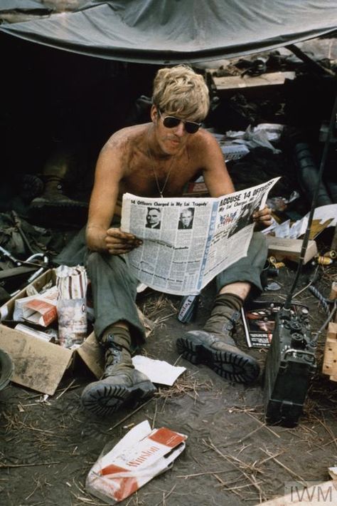 An off-duty American soldier, PFC Mark Kramer, of 2 Bn, 8 Regt, 1 Air Cavalry Division, reads a copy of the US Department of Defense newspaper 'Pacific Stars and Stripes' at Fire Support Base Jay, 4 miles from the Cambodian border, 21 March 1970. The newspaper's headline refers to the My Lai Massacre of 1968. Vietnam History, Department Of Defense, American Soldier, North Vietnam, South Vietnam, Us Soldiers, American Soldiers, Vietnam Veterans, United States Army