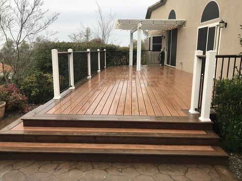 Trex deck in Tiki Torch with Spiced Rum border. Fortress iron rail in antique bronze with white posts & top cap. Two Tone Trex Decking, Deck With Border, Tiki Torch Trex Decking, Wood Sidewalk, Trex Tiki Torch Decking, Trex Deck Ideas Color Schemes, Deck Border, Deck Colours, Trex Deck Tiki Torch