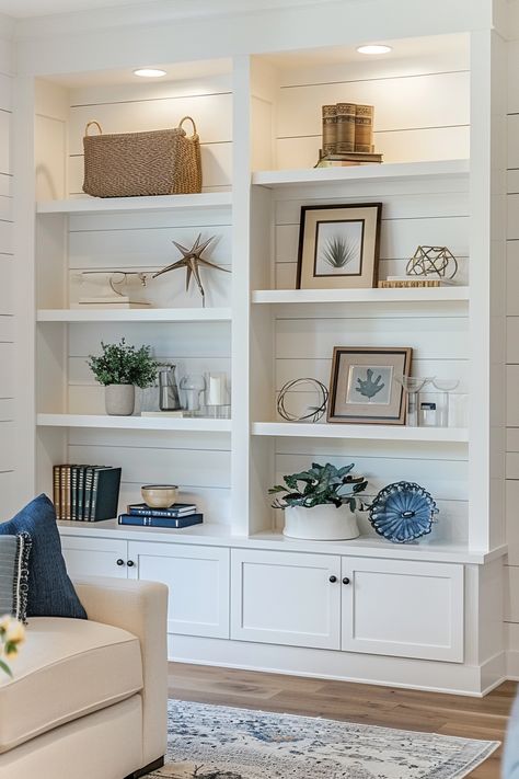 Living Room Essentials Decor, Coastal Bookshelf Decor Bookcase Styling, Beach House Bookshelf, Shiplap Bookshelf, Living Room Bookcase Decor, Modern Hamptons Style Living Rooms, Trendy Bookshelf, Living Room Bookshelf Ideas, Coastal Bookshelf