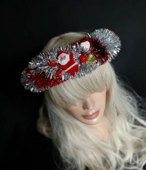 A delicate Christmas hair crown is beautiful handmade wrapped with Christmas symbols in red colors and white for a fun combination. The hair wreath is perfect for parties, especially for Christmas and new year. The Christmas headband is made of artificial materials, so it is very durable. The headband is made with great attention to detail Christmas Crown, Wreath Crown, Christmas Party Hats, Christmas Symbols, Hair Crown, Hair Wreath, Christmas Headband, Christmas Costume, Christmas Hair