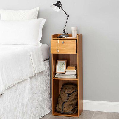 Latitude Run Keep your essentials within arm’s reach while you sleep with this nightstand. Two shelves of open bottom storage are ideal for displaying decorative keepsakes or quick access to books or a laptop. A single sliding drawer keeps smaller accessories out of sight. This extra height compact nightstand is sized perfectly for raised beds and small space bedrooms and is a great solution for your bedroom organization. Colour: Beech Dorm Nightstand, Bedside Table Ideas, College Furniture, Tall Bedside Table, Tall Nightstand, Tall Nightstands, Bed Nightstand, Shelf Nightstand, Small Nightstand