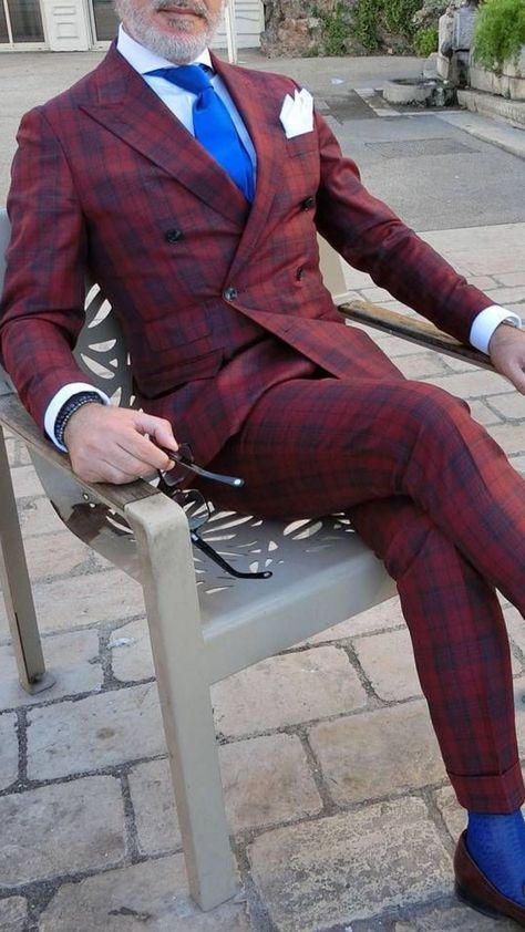 Man is wearing a burgundy plaid double breasted suit with a white collard shirt and a blue tie. Burgundy Plaid Suit Men, Wedding Suit Burgundy, Plaid Wedding Suit, Burgundy Suit Men, Burgundy Jacket Outfit, Sport Coat Outfit, Plaid Suit Men, Plaid Wedding, Maroon Suit