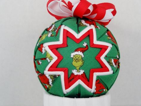 Item is ready to ship.  Adorable one of a kind gift to decorate your tree or mantel. Unique Quilted Ornament made from 100% cotton fabric, 3 styrofoam ball, straight pins and ribbon. Each ornament is handmade and takes approximately two hours to make. No two are exactly alike.  ^^^^NOTE: contains straight pins, please keep away from small children and animals^^^^  Handmade in a smoke free home. Grinch Fabric, Quilt Ornaments, Grinch Tree, Grinch Trees, Grinch Decorations, Fabric Ornament, Grinch Party, Fabric Balls, Grinch Ornaments