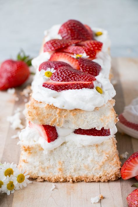 Light, fluffy, and sweet Strawberry Angel Food Cake. Put the season's sweet and tasty strawberries to sweet use in this strawberry dessert recipe. Angel Cake With Strawberries, Angel Food Cake Decoration, Angel Food Wedding Cake Ideas, Angel Food Cake Layer Cake, Angel Food Cake In Loaf Pan, Angel Food Cake Recipes Loaf Pan, Fancy Angel Food Cake, Angel Food Cake Loaf Pan, Strawberry Shortcake Loaf Cake