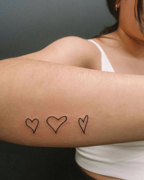 Love Heart Tattoo On Arm, Trio Heart Tattoo, Hearts On Arm Tattoo, Heart Tattoo On Side Of Wrist, Heart Tattoo On Forearm, Heart Tattoo Handwriting, Hand Drawn Heart Tattoo Placement, Handwritten Heart Tattoo, Hearts In A Row Tattoo