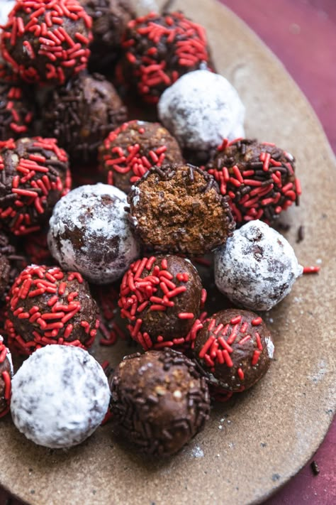 This easy rum balls recipe only takes 20 minutes to make, with simple ingredients and a food processor! It's a no nut recipe that uses vanilla wafer cookies as a base - but you can use any crunchy cookie! This no bake Christmas dessert is perfect to make ahead of the holidays as it stores easily and freezes well. These rum balls are moist, boozy, festive, and fun to make or give as holiday gifts! No Bake Chocolate Rum Balls, Booze Balls Recipe, Nut Free Rum Balls, Rum Balls No Nuts Recipe, Rum Ball Recipe, Easy Rum Balls Recipe, Alcohol Candy Recipes, Rum Balls With Vanilla Wafers, Rum Balls Recipe Christmas