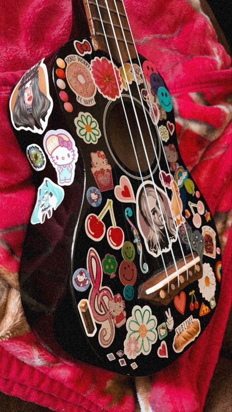 stickers on a ukulele Guitar Design Ideas Stickers, Ukelele Decoration Ideas, Guitar Decorating Ideas, Guitar Covered In Stickers, Stickers On Guitar Acoustic, Ukulele Design Ideas, Decorated Acoustic Guitar, Guitar Stickers Aesthetic, Stickers On Guitar