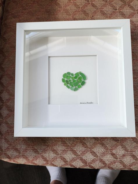 Framed Seaglass in a Heart Shape. This surf tumbled green seaglass from Hawaii. Seaglass Canvas Art, Seaglass Collection Display, Seaglass Art Ideas, Sea Glass Art Ideas, Seaglass Picture, Seaglass Ideas, Beach Glass Projects, Seaglass Crafts, Sea Glass Artwork