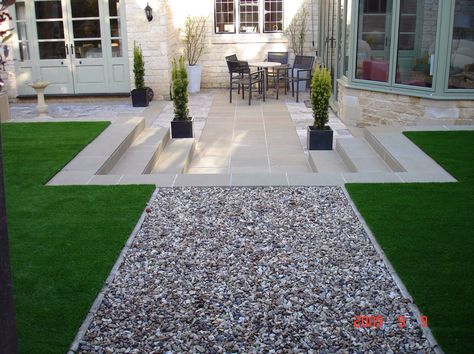 Artificial lawn, pea gravel, steps and light stone paving Tuscany Garden, Level Backyard, Level Garden, Artificial Grass Backyard, Beauty Cabin, Cabin Garden, Best Artificial Grass, Grass Installation, Austin House