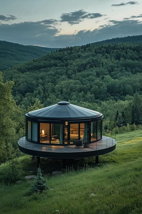 Prefab glass nad matte black steel round yurt on a large platform in a green valley. Check out all of these innovative and stylish prefab homes that bring modern designs to life. This is the future of cheap and sustainable living! Modern Glamping House, Yurt Home Ideas, Permanent Yurt Home, Circular House Design, Luxury Homesteading, Yurt Platform, Large Tiny House, Modern Yurt, Yurt Cabin